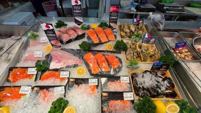 Seafood counter on ice with salmon, tuna and shellfish at Villa Market Thonglor